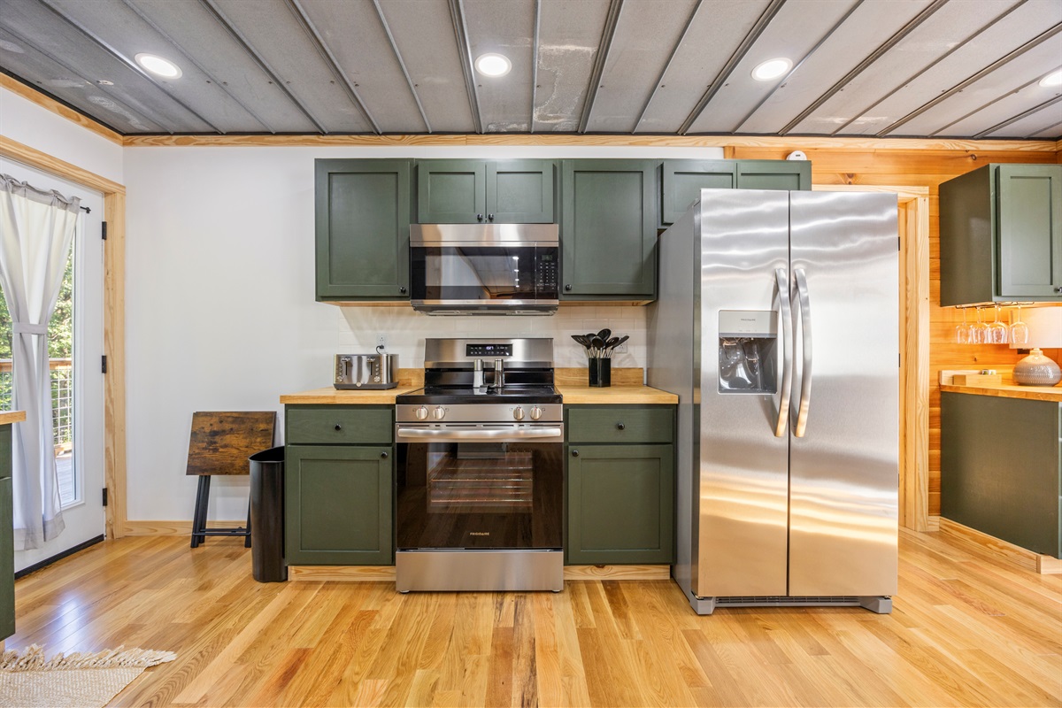 Fully equipped kitchen with stainless appliances, coffee maker, and everything you need for meals in.
