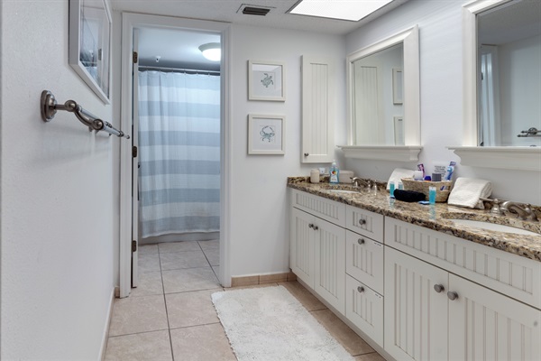 Main ensuite bathroom with dual sinks and a separate toilet/bath area