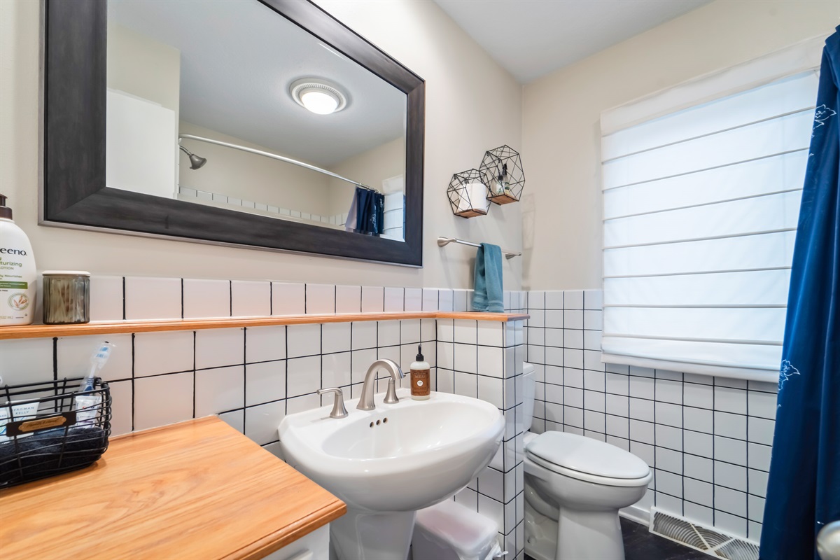 Full bathroom on the main floor that features a jetted tub, tall shower, hairdryer, first aid, travel size shampoo and conditioner, and feminine products.