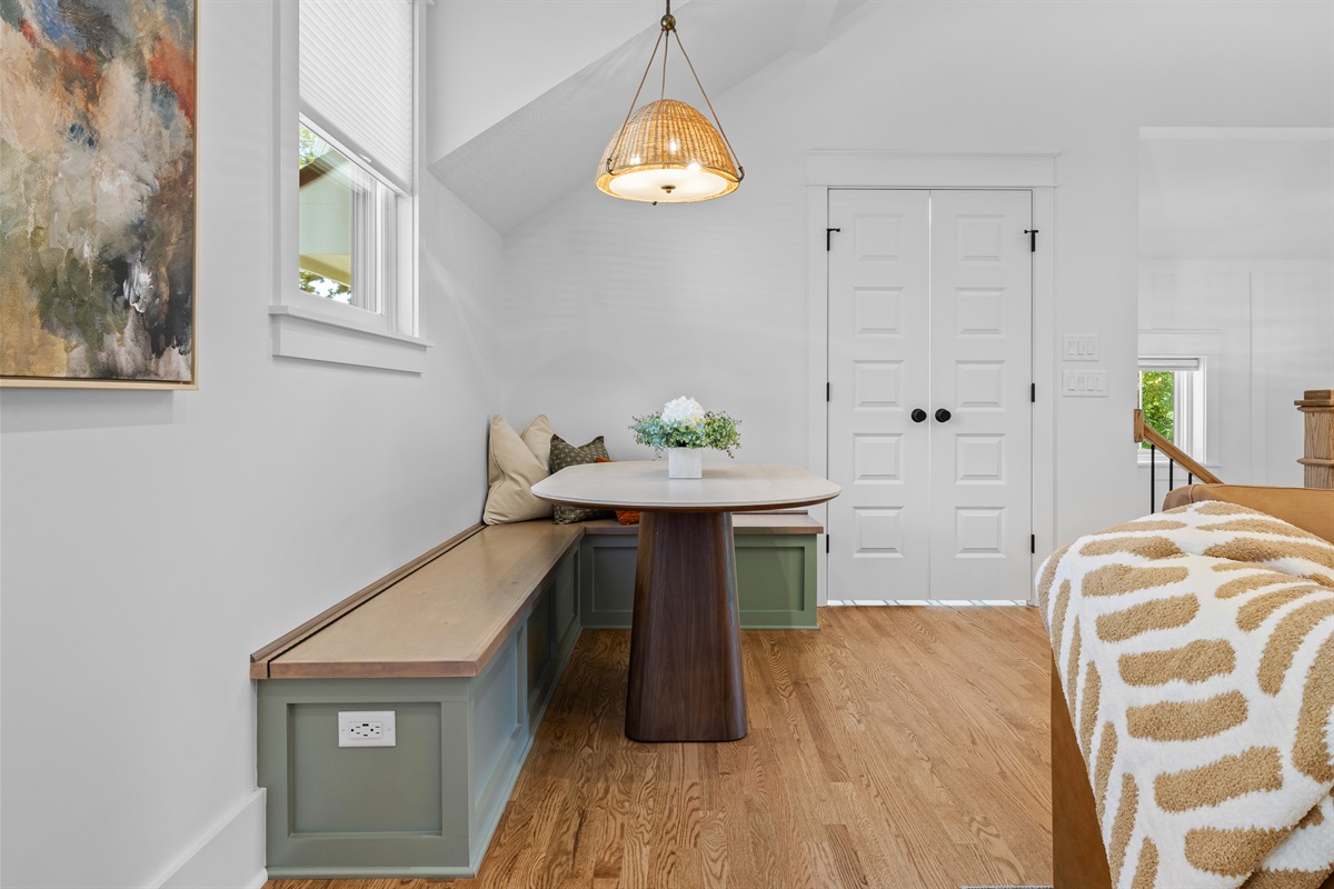 Cozy corner dining area with extra seating and outlets for work or play.