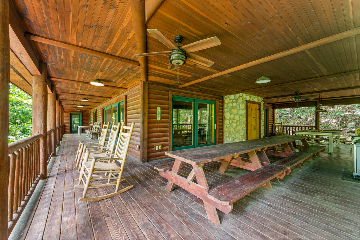 1100 square foot covered deck with three picnic tables and propane BBQ grill.