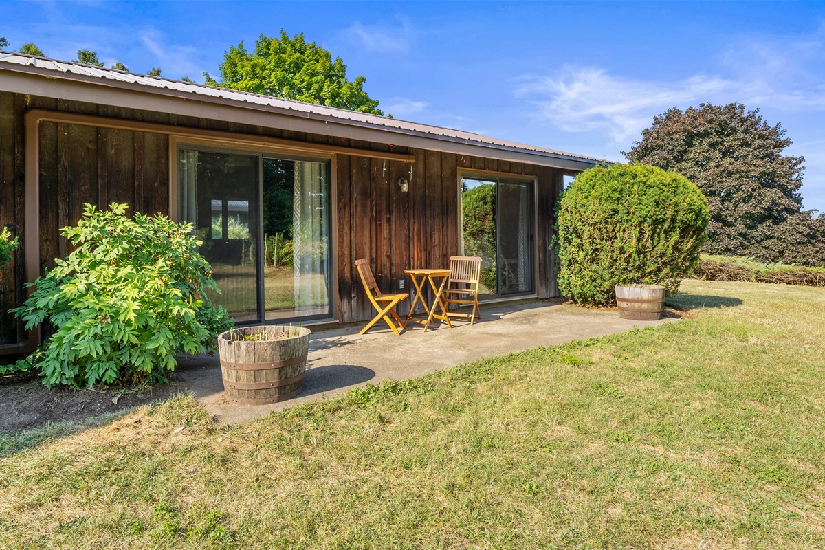 Cozy patio nook with sliding glass doors, perfect for enjoying morning coffee or an evening glass of wine.