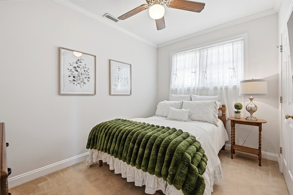 Another cozy bedroom with soft, simple lake-house style.
