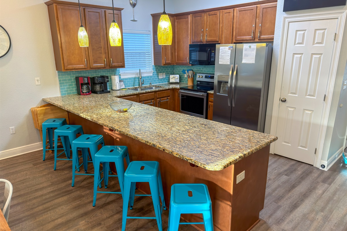 Created for entertaining, the kitchen features generous seating, modern stainless-steel appliances, and a spacious pantry for convenience.