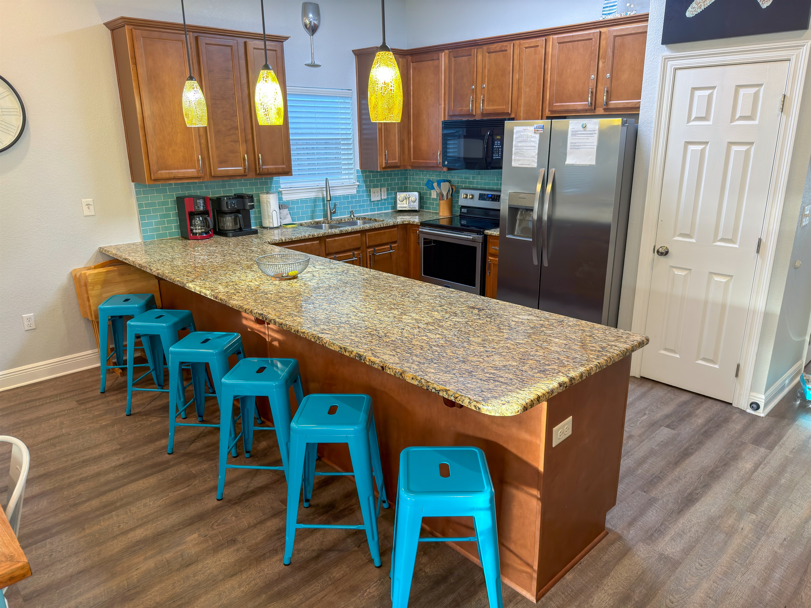 Created for entertaining, the kitchen features generous seating, modern stainless-steel appliances, and a spacious pantry for convenience.