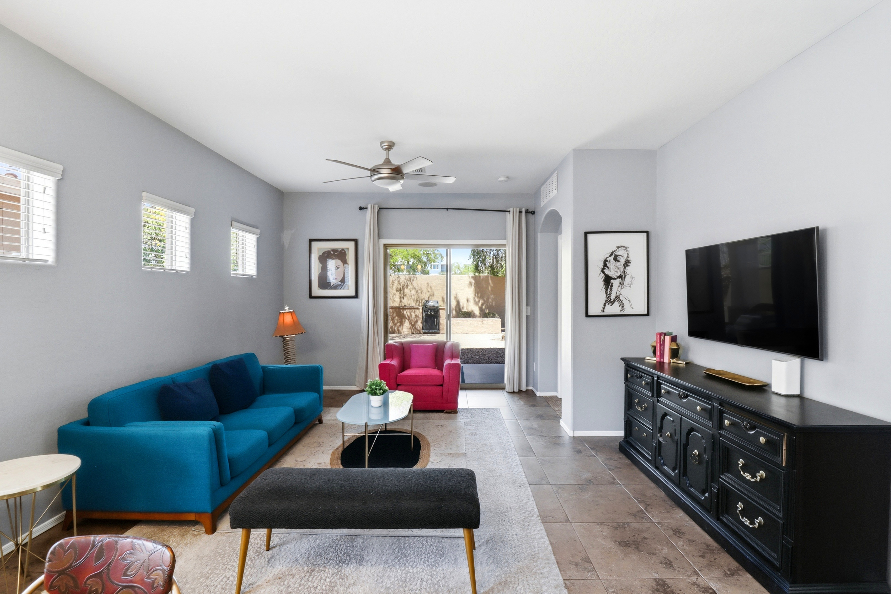 Living room with colorful seating, a TV, and patio access right off the main space.