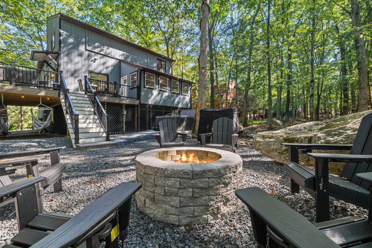 Rustic stone-lined fire pit  and Adirondack chairs, perfect for nighttime gatherings and roasting s'mores