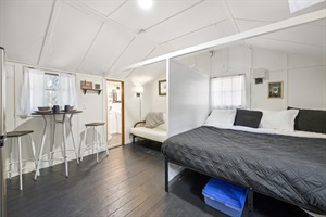 Side point of view of king bed, futon and