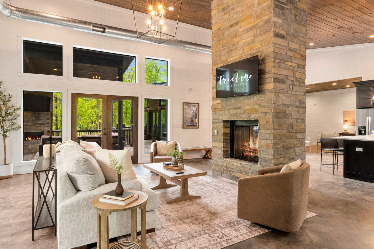 The living room pairs comfort with style, offering plush seating and an elegant fireplace, making it the ideal spot to relax after a day of adventure or simply enjoy a quiet evening in.