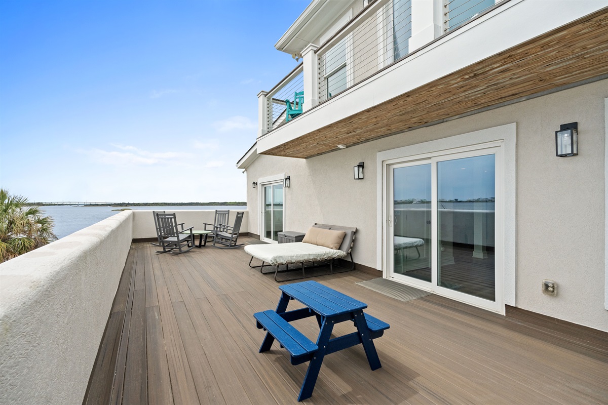 Large private deck with multiple seating areas perfect for soaking in the coastal breeze