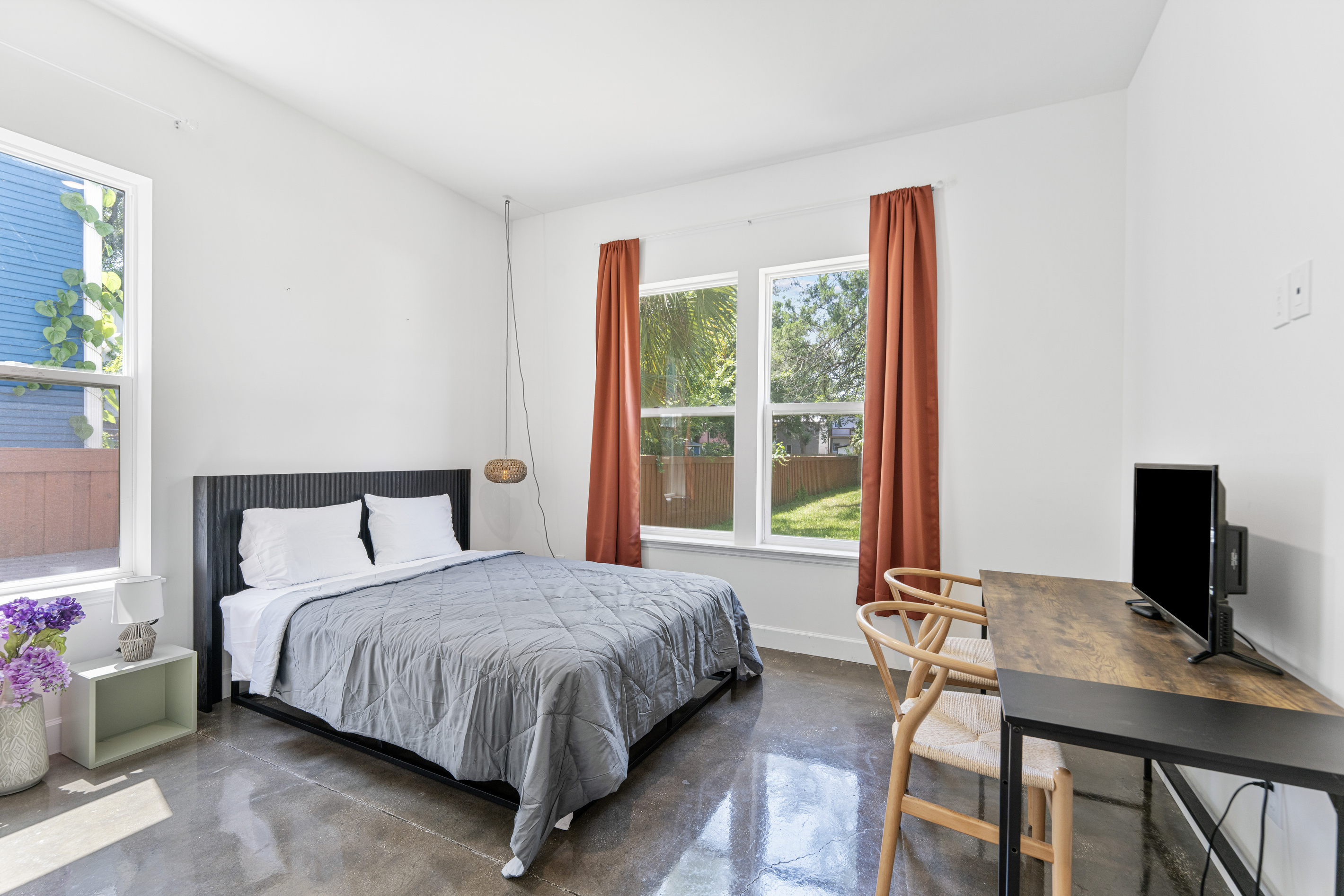 The downstairs bedroom, perfect for grandparents who would rather skip the stairs or whoever calls it first. A desk by the window for early risers, a garden view, and a door that closes on the happy noise above.