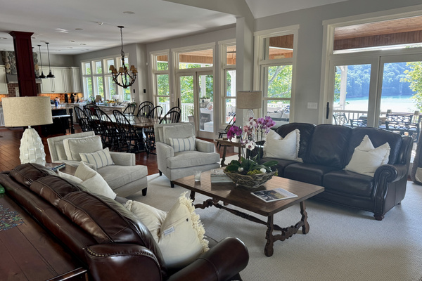 Floor-to-ceiling windows showcase breathtaking sunset views over Norris Lake