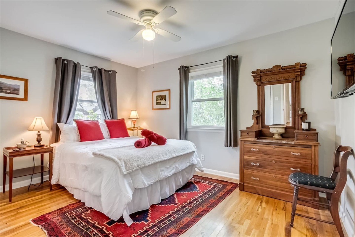 
Step into this cozy, primary bedroom, filled with warm touches and old-fashioned charm. It’s a comfortable, inviting space to slow down and relax after a day of exploring, with a convenient half bath attached.
