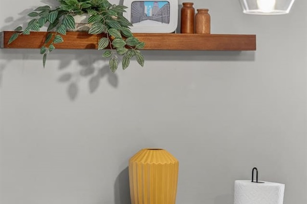 Modern design details with floating wood shelf, greenery, and chic décor accents. This stylish bar counter adds charm to the kitchen and dining area, blending function and contemporary style.