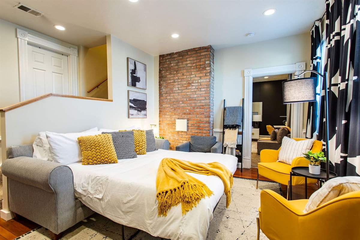 Living area featuring a comfortable couch, a stylish center table, and tasteful wall décor, creating a cozy and aesthetically pleasing space to relax and unwind.
