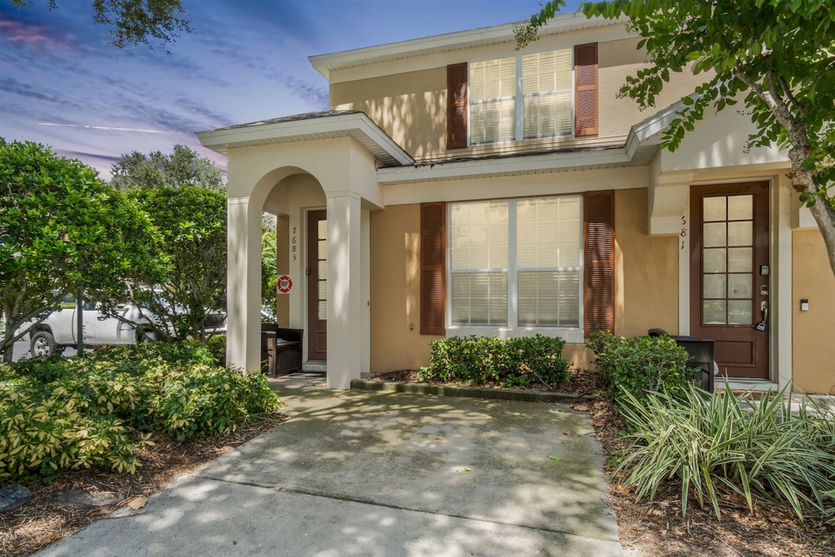 Front view with parking spot and additional parking on the side.