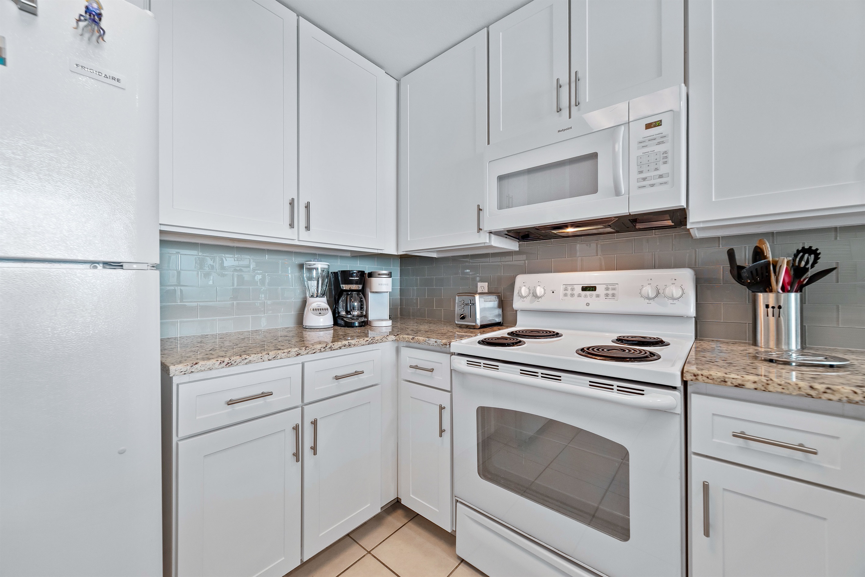 Modern kitchen essentials at your fingertips. This countertop setup offers everything you need for a quick breakfast or a relaxing cup of coffee.