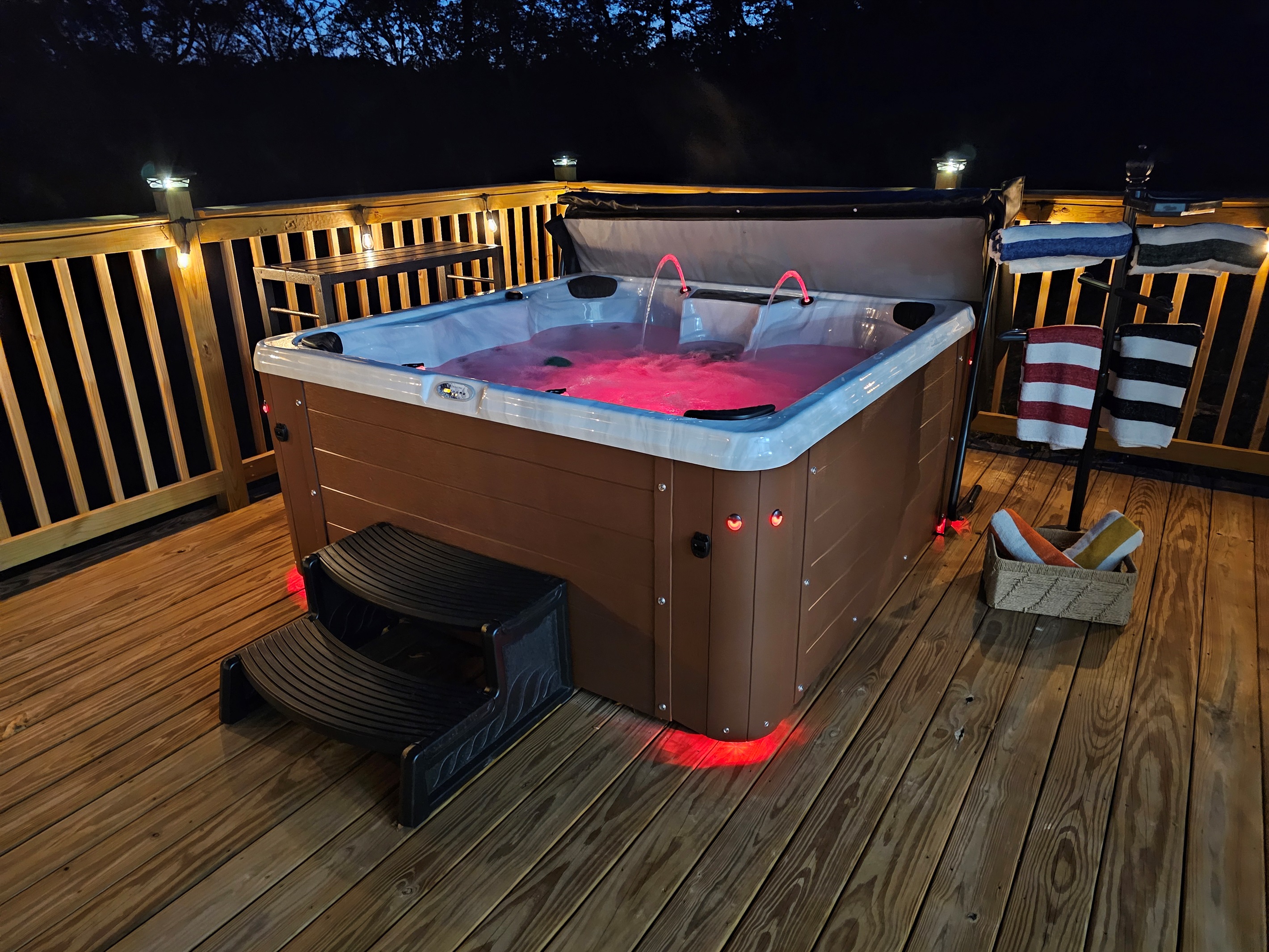 Soak in your private hot tub under glowing deck lights—perfect for romantic nights beneath the stars