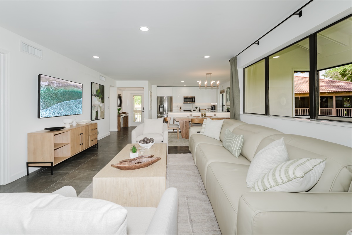 Seamless indoor-outdoor feel with large windows overlooking the fairway. Bright, open living space filled with natural light and golf course views. Comfortable seating is perfect for relaxing after a day at the beach or golf. 