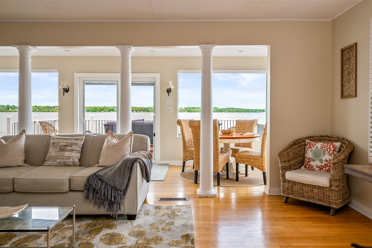 Bright and airy living space with panoramic lake views and direct access to the waterfront deck 🌊🛋️☀️