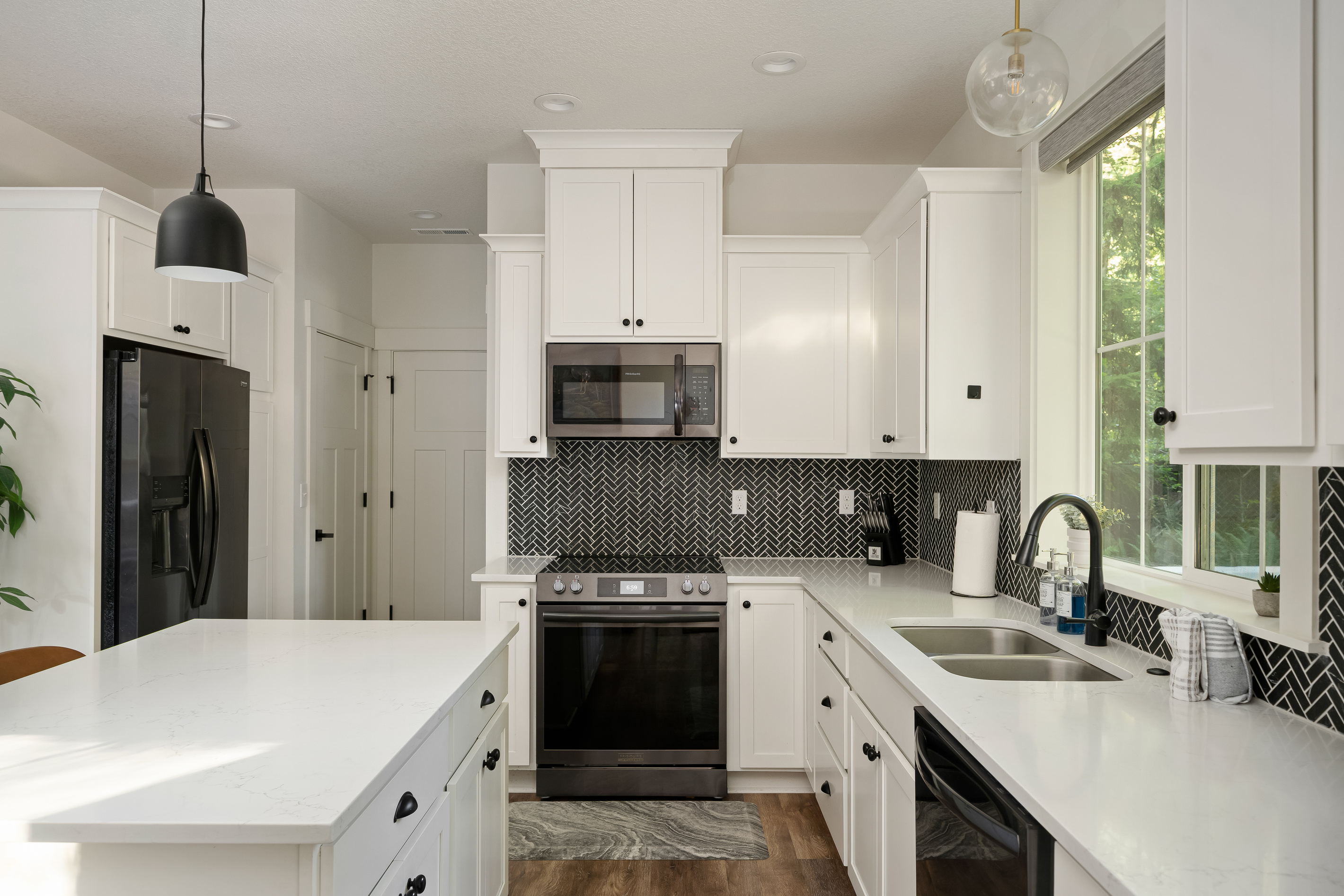 A chef-ready kitchen with quartz counters and herringbone tile, made for cooking up mountain memories.