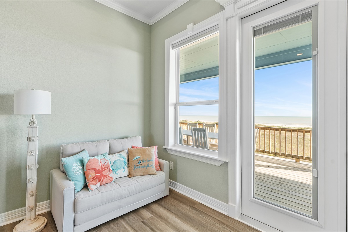 Comfortable couches and plenty of light complete the master bedroom.