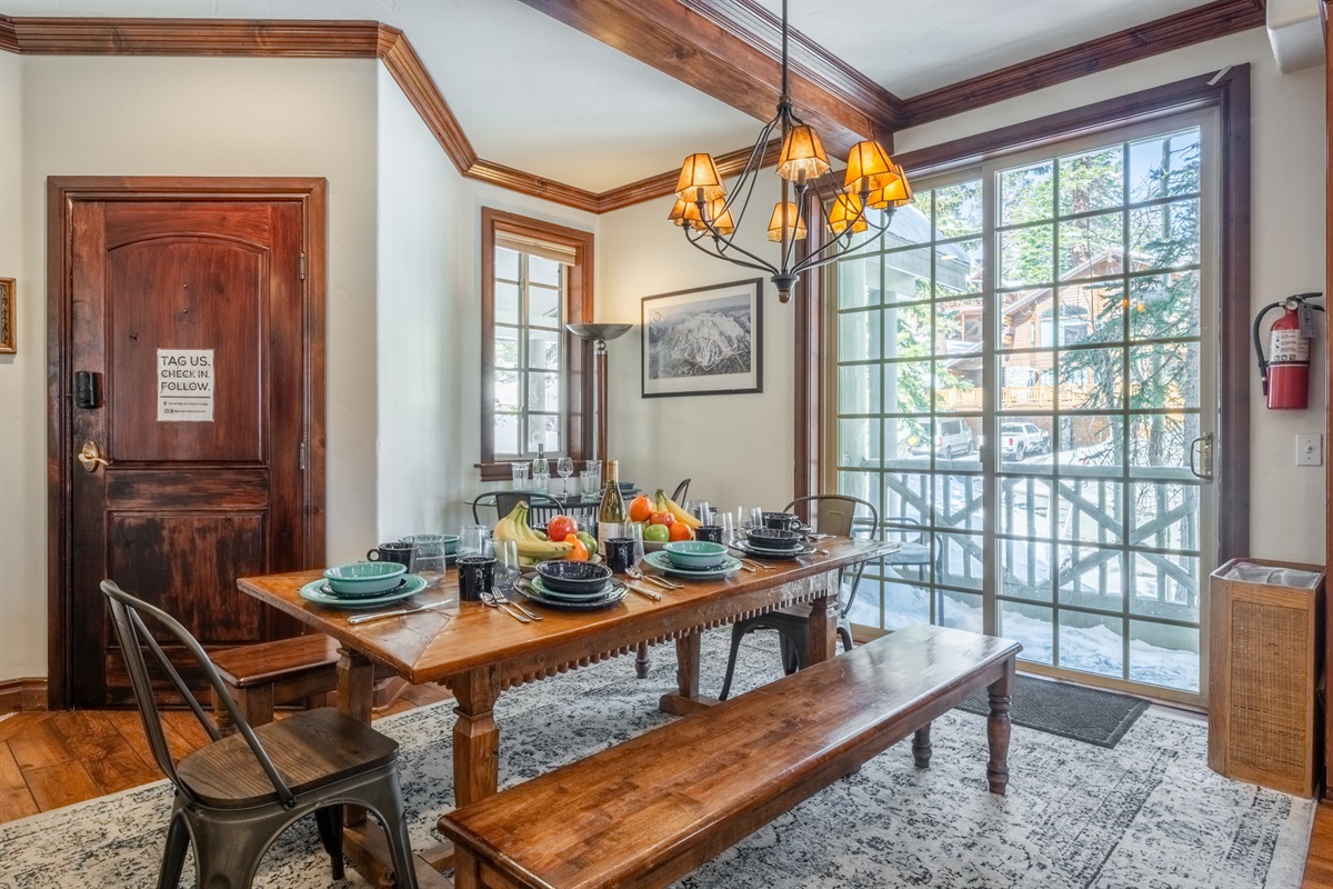 Dining area filled with natural light from the large sliding window, opening to a Juliet balcony, with a tucked-away table ideal for casual dining or a dedicated workspace.
