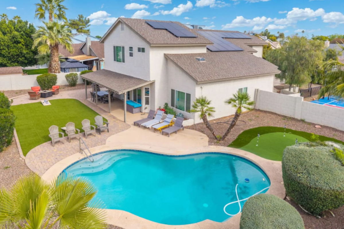 Stunning desert home with resort-style pool, solar panels, and manicured grounds perfect for groups.