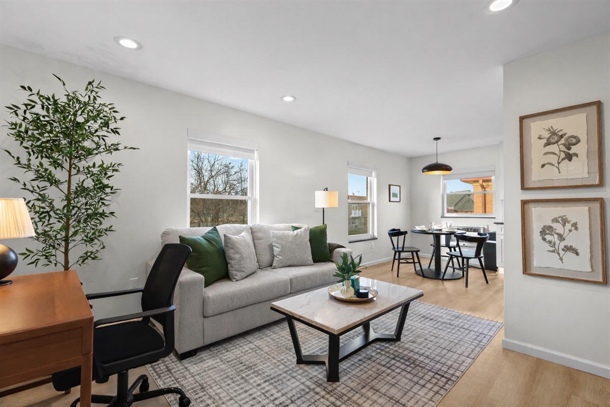 Spacious, light-filled living area with cozy seating, modern décor, and seamless flow to dining—perfect for relaxing, working, or hosting with ease.