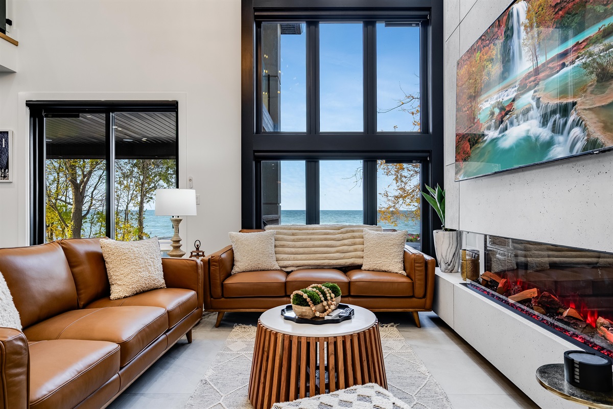 Orangish-brown accents in seating and cabinetry details create cohesion.