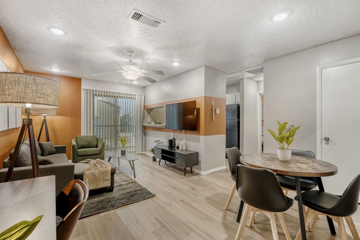 Warm, cozy living space with comfortable seating and a dining area