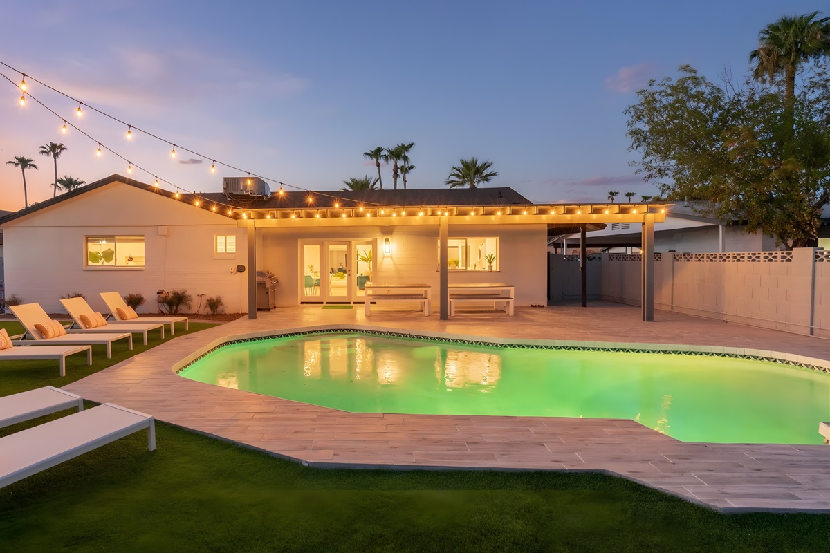 Spend the evening lounging by the pool with string lights glowing