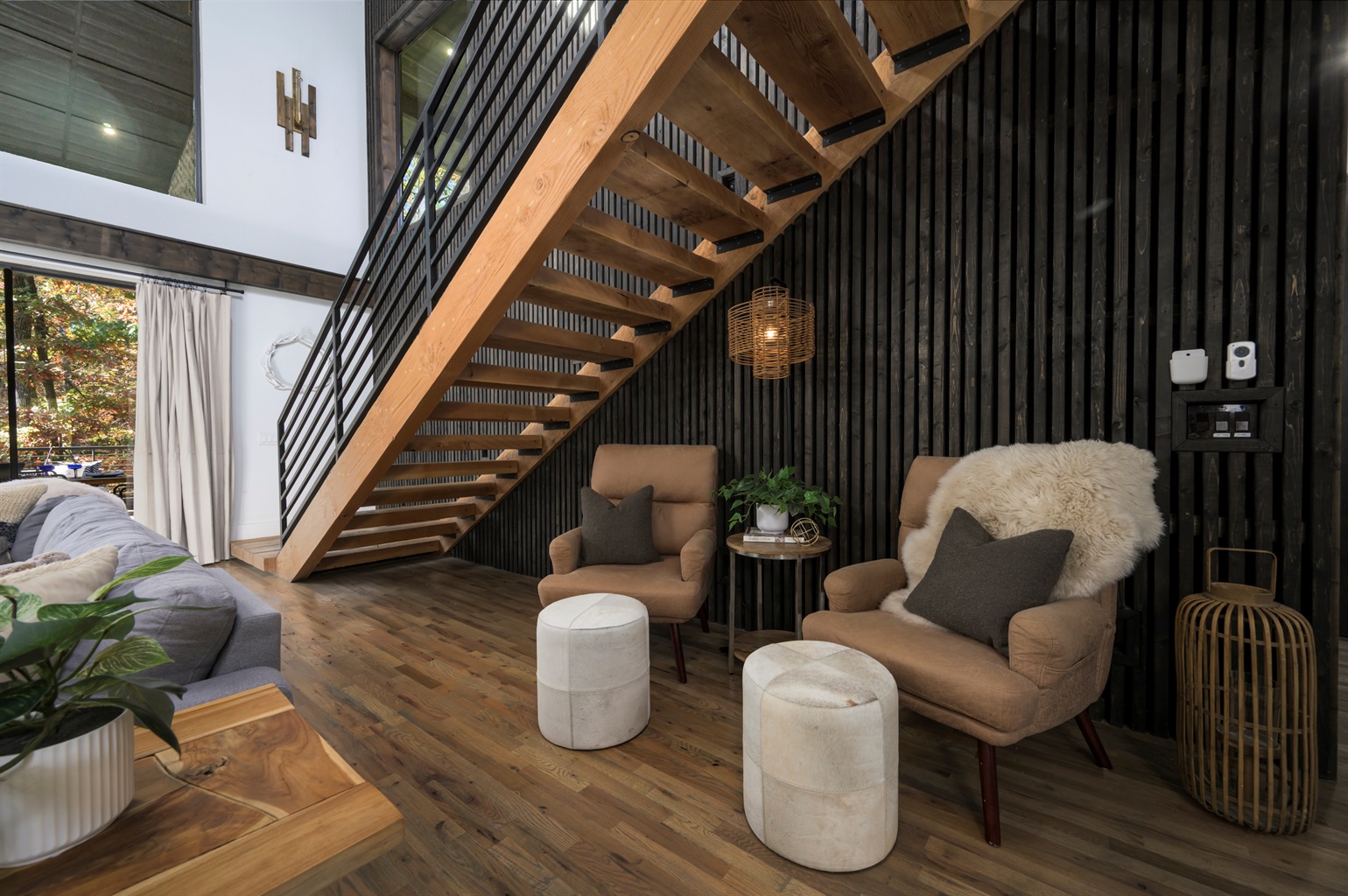 Thoughtfully designed lounge space beneath the staircase, blending modern architecture with cabin warmth