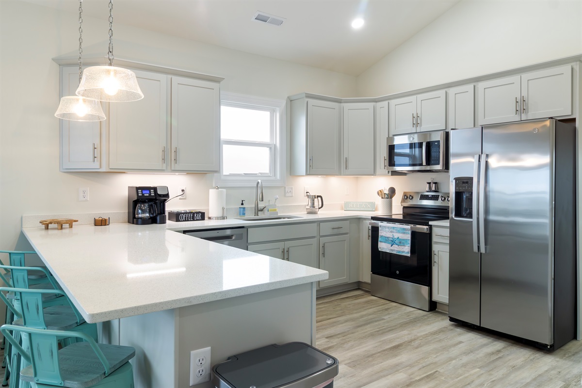 Well stocked kitchen with counter seating for 4