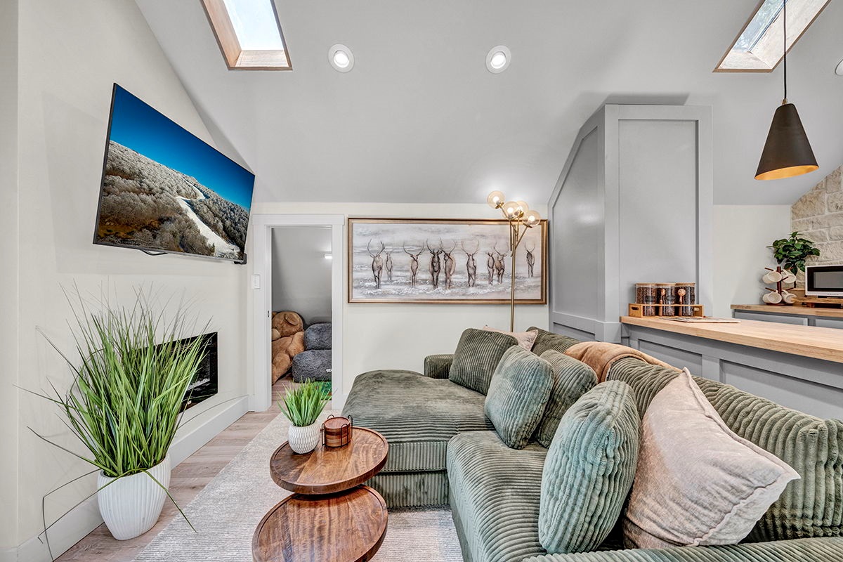 Cozy Living Room with 55-inch Smart TV, Fireplace, and bistro table.