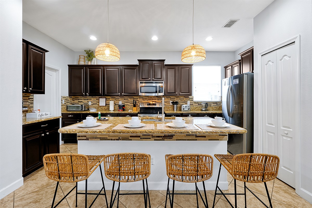Granite countertops on the background of a fully equipped kitchen with stainless steel appliances