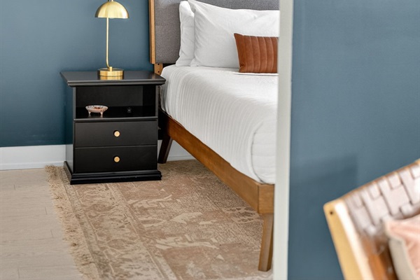 Sleep in style with a crisp, modern bedroom setup—featuring rich textures, ambient lighting, and a calming color palette.