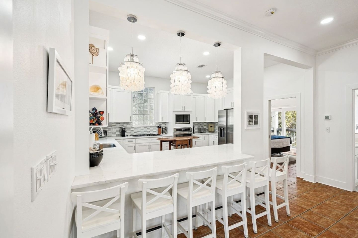 Bright kitchen counter seating opening up to the main living areas.