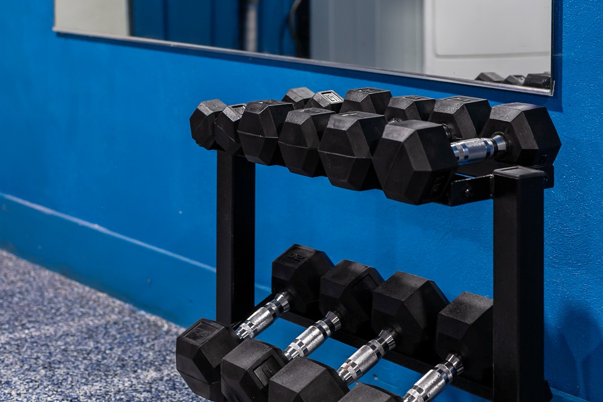 A variety of dumbbells are available in the fitness area for different workout styles