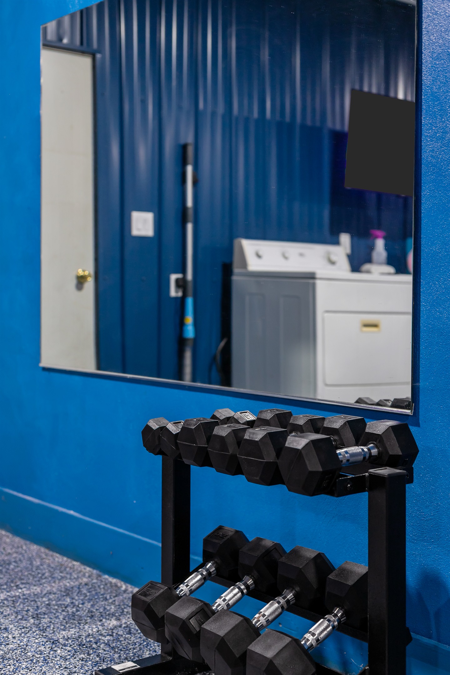 A variety of dumbbells are available in the fitness area for different workout styles