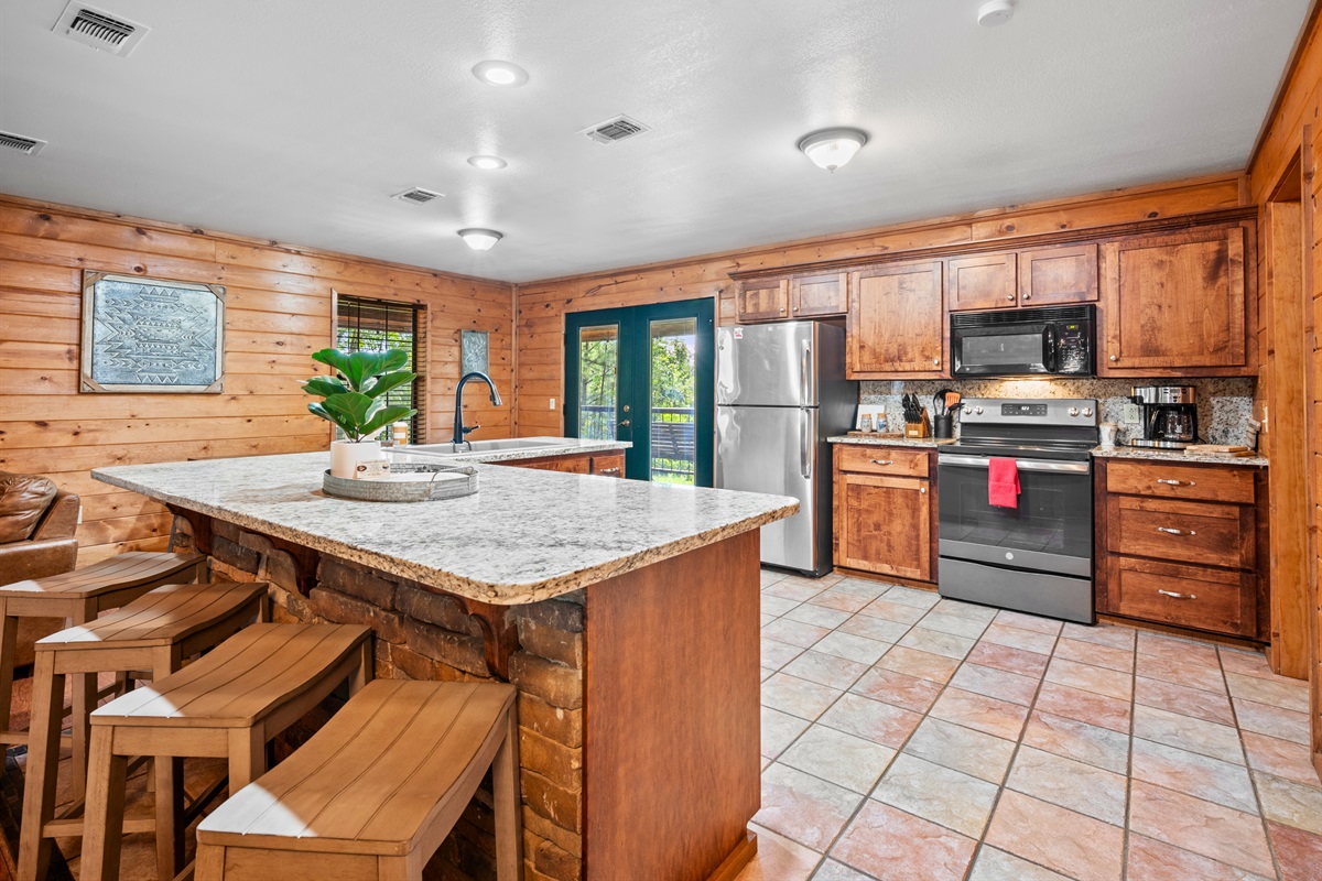 The kitchen island doubles as a breakfast bar with room for the whole group.