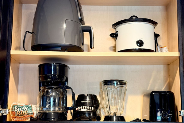 Small appliances include a drip coffee maker, toaster, electric kettle, and slow cooker.