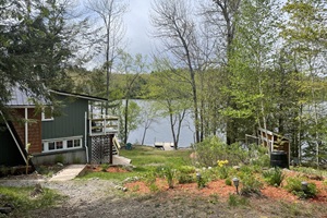 Picture from the front that shows path on side to the like , that takes to the dock