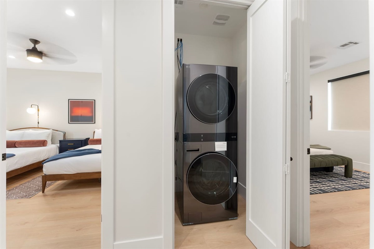 Convenient upstairs laundry with modern stacked washer and dryer, perfectly located near the bedrooms for easy access.