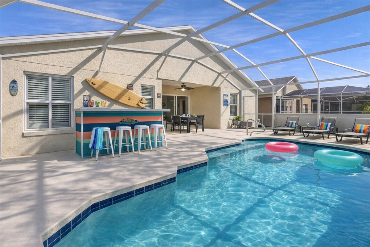Enjoy a private screened pool area with seating and a poolside bar for relaxing afternoons.