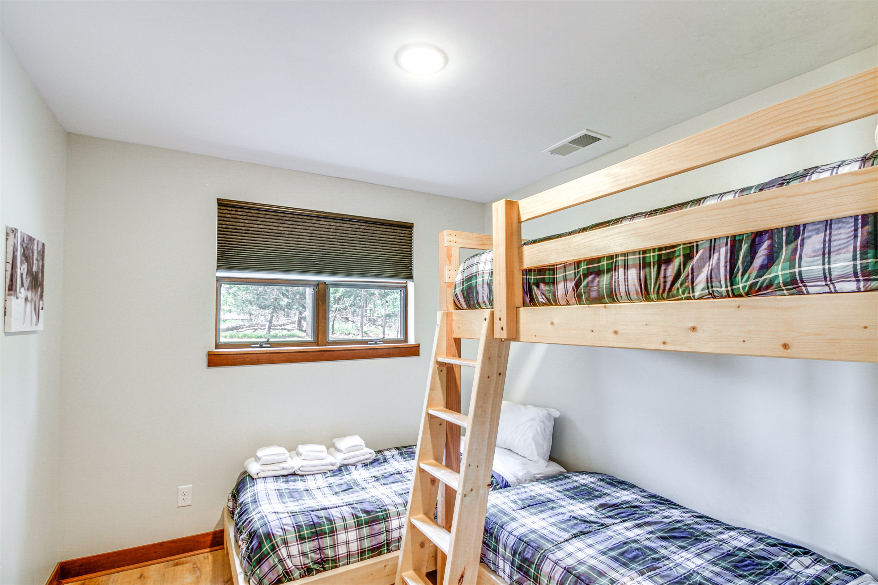 Family-friendly bunk room featuring twin-over-twin bunks and natural light—perfect for kids or extra guests.
