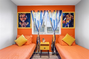 Bedroom 3 with twin-beds compensated with warm and vibrant hues