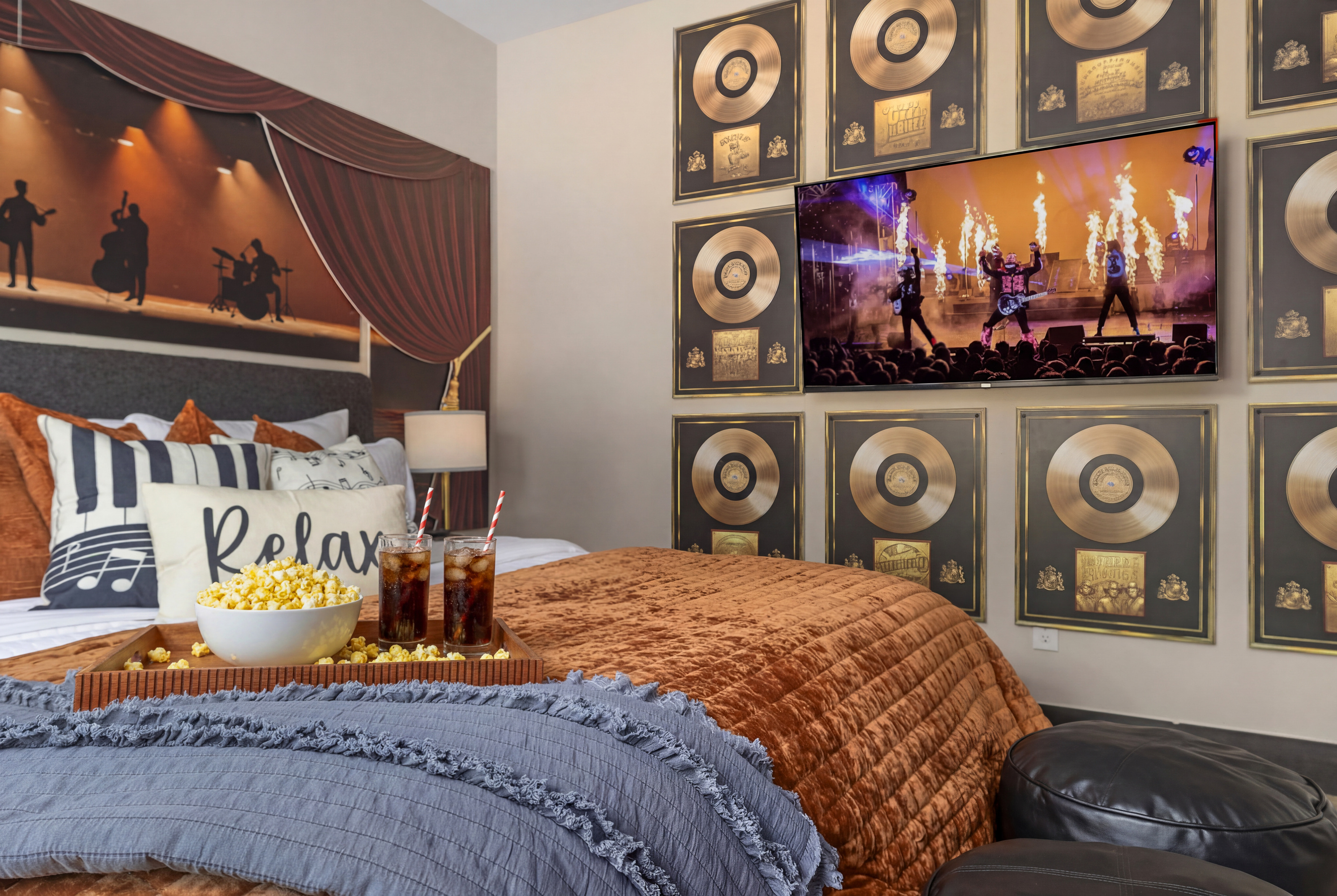 The concert plays on-screen beside a wall of records.