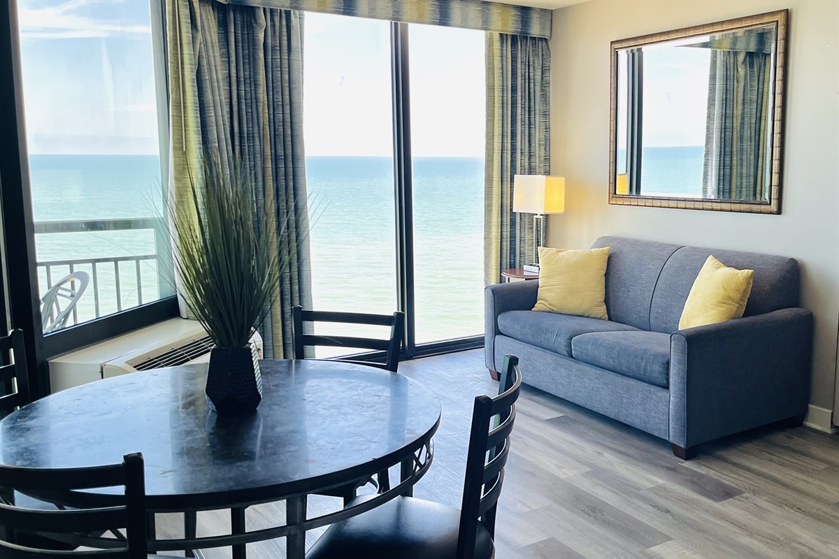 Experience open-air comfort in the living area, where the sliding glass doors bring in the coastal breeze, creating a refreshing and inviting space.