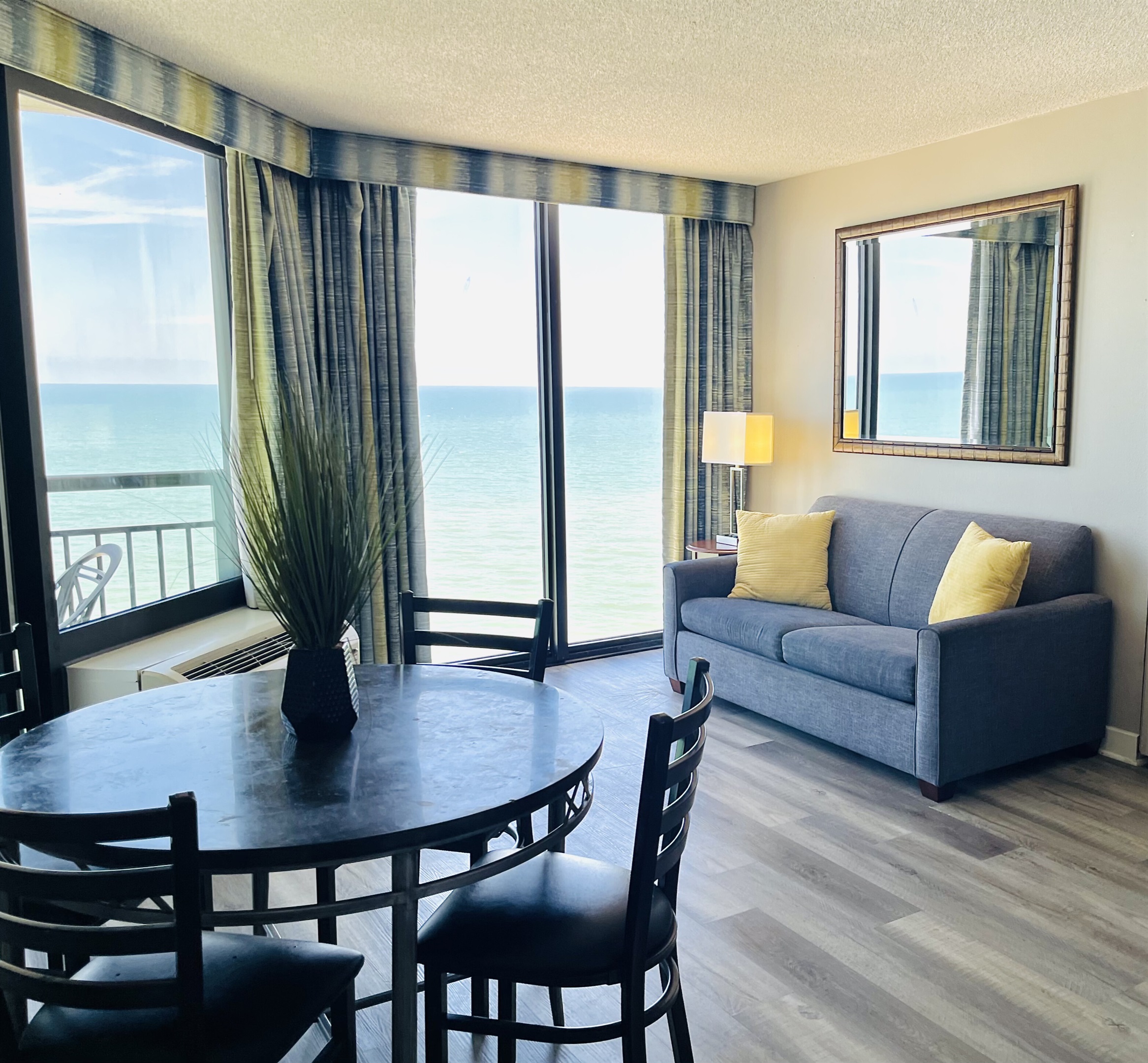Experience open-air comfort in the living area, where the sliding glass doors bring in the coastal breeze, creating a refreshing and inviting space.